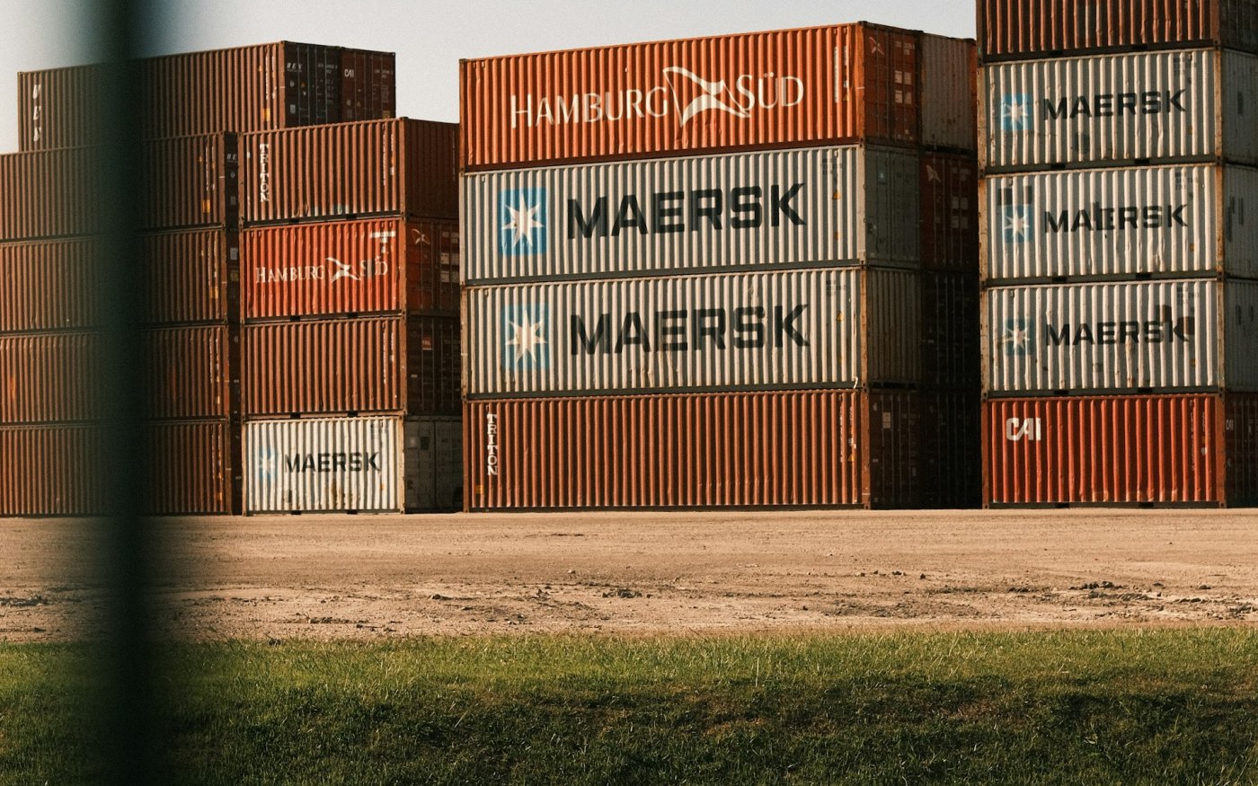 Shipping containers stacked at a port terminal — moisture risk during ocean freight
